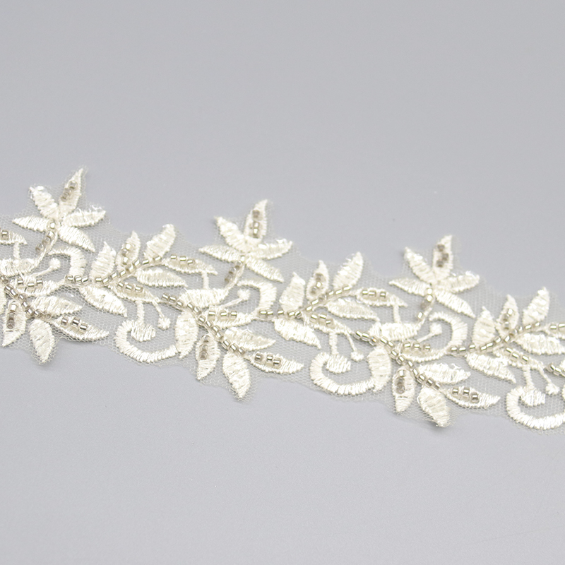 Multicolored handmade embroidered lace trim with sequin and bead accents, made with eco-friendly materials.