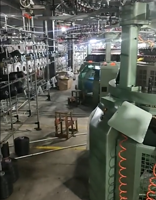 Wide view of automated embroidery and ribbon-weaving equipment manufacturing piping cord edges and grosgrain ribbon lace trims, showcasing custom colors, widths, and rapid sampling services.