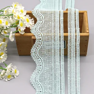 Soft and flexible polyester water soluble lace with intricate embroidery, ideal for bridal gowns and fashion dress applications.