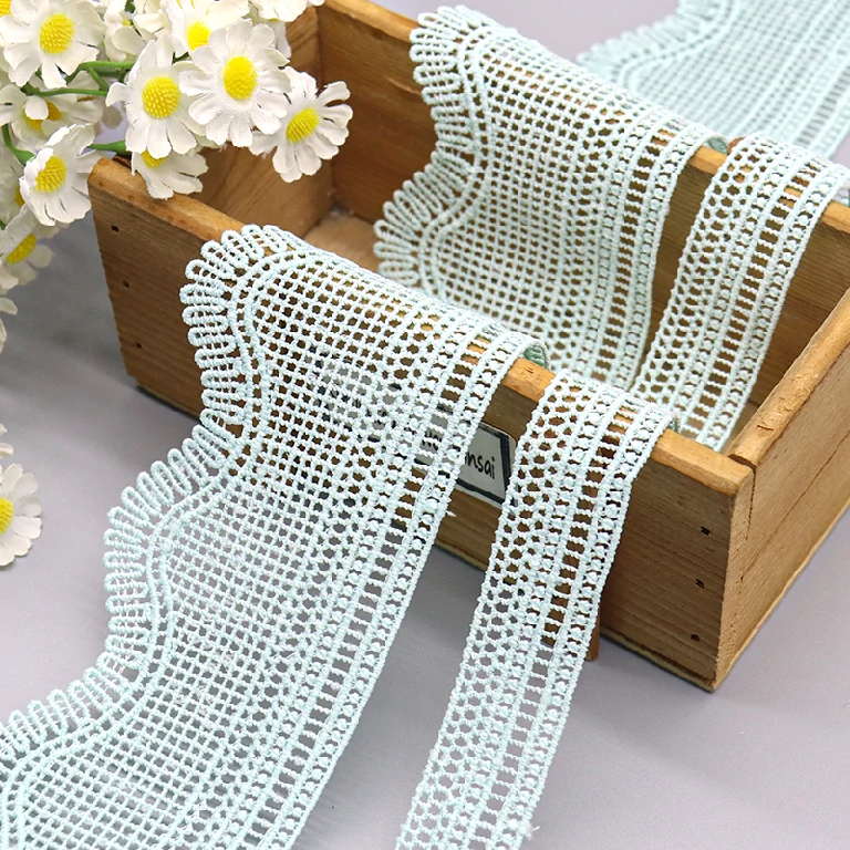 Beautiful polyester lace trim, water soluble with floral patterns, suitable for various textile crafts and clothing embellishments.