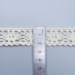 Intricately patterned cotton thread lace trim, suitable for garment embellishment and creative textile applications.