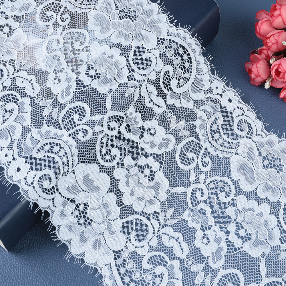 Soft ivory vintage lace in a polyester–cotton blend with Chantilly-look florals, ideal for bridal overlays and sleeve trims.
