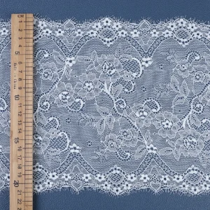 Soft and finely crafted lace trim featuring classic motifs, ideal for dressmaking, sewing, and creative craft projects.