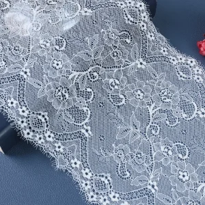 High-quality black lace trim decorated with detailed floral patterns, suitable for elegant evening wear and formal clothing.