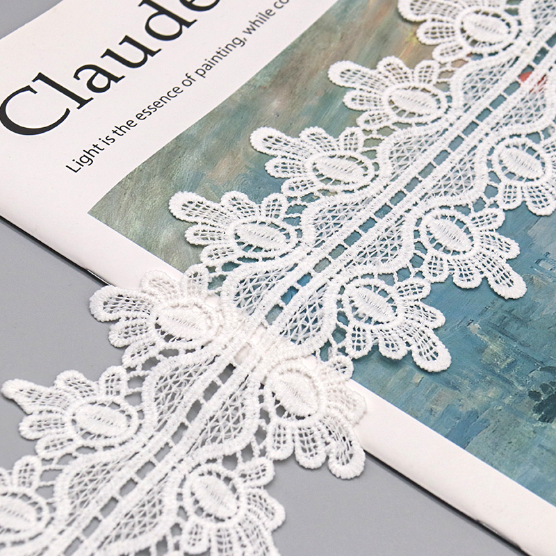 Sample card displaying multiple widths of water soluble and chemical lace ribbons with scalloped borders and color variations.