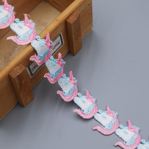 Assorted pre‑dyed colored water soluble lace trims beside PFD white dyeable lace, showcasing Pantone color‑match options for custom branding.