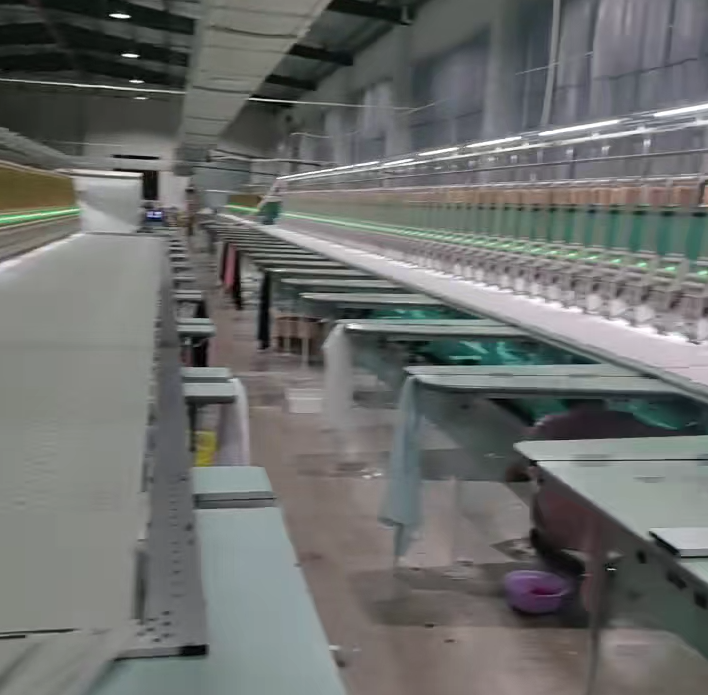 Production hall showing dedicated lines for water soluble embroidery and chemical lace etching to support custom orders.