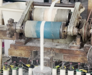 Interior of a cotton thread lace factory featuring automated embroidery machines producing high-quality lace trims efficiently.