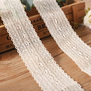 Beige cotton lace with fine embroidered motifs compared to a multicolor tassel lace trim, showing options for trendy and classic home textile customization.