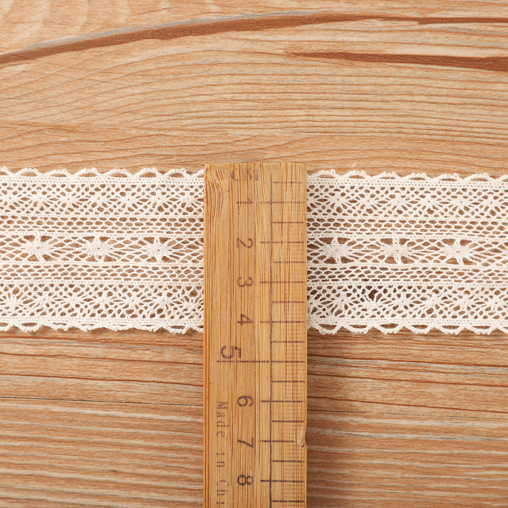 Detailed image of traditional beige cotton lace and a contrasting colorful tassel lace, perfect for ODM projects like table runners or throw pillows.