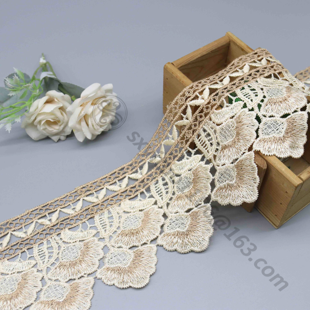 Highly detailed embroidery water soluble lace and structured eyelet water soluble fabric, photographed for use in creative OEM garment lines.