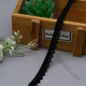 Close-up of 1.1 cm wide black elastic webbing lace trim with clean, simple lines and fine lace edging creating subtle wave details for refined aesthetics; stretchy and comfortable, ideal for wholesale garment sewing, underwear accents, and handmade clothing projects.