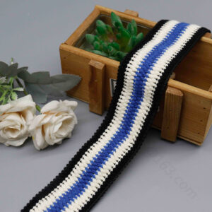 Close-up of 4.5 cm wide color-blocked poly cotton canvas webbing featuring bold black, white, and blue segments with interwoven blue-white center and black lace edging for layered detail; durable and visually striking, perfect for belts, bag straps, and DIY fashion projects.