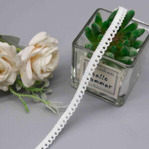 Detailed view of factory-direct 0.8 cm white lace trim with a sew-friendly straight knit edge and gentle micro-arc scallop waves, interspersed with small hollow eyelets for transparent charm; fully embroidered lines provide crisp definition and subtle rigidity, suited for Lolita skirt edges and craft decorations.