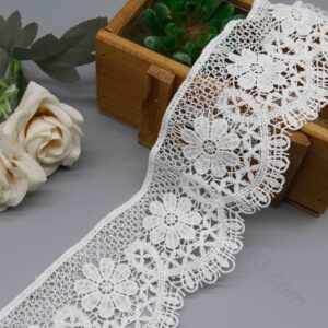 Elegant shot of fresh milk silk polyester water-soluble lace trim in pure snow white, emphasizing hollow Guipure craft with rich floral and geometric embroidery, enhanced by wave edge layering for a 3D classic appeal; moderate width ideal for dress collars, skirt hems, bag trims, and refined garment personalization.