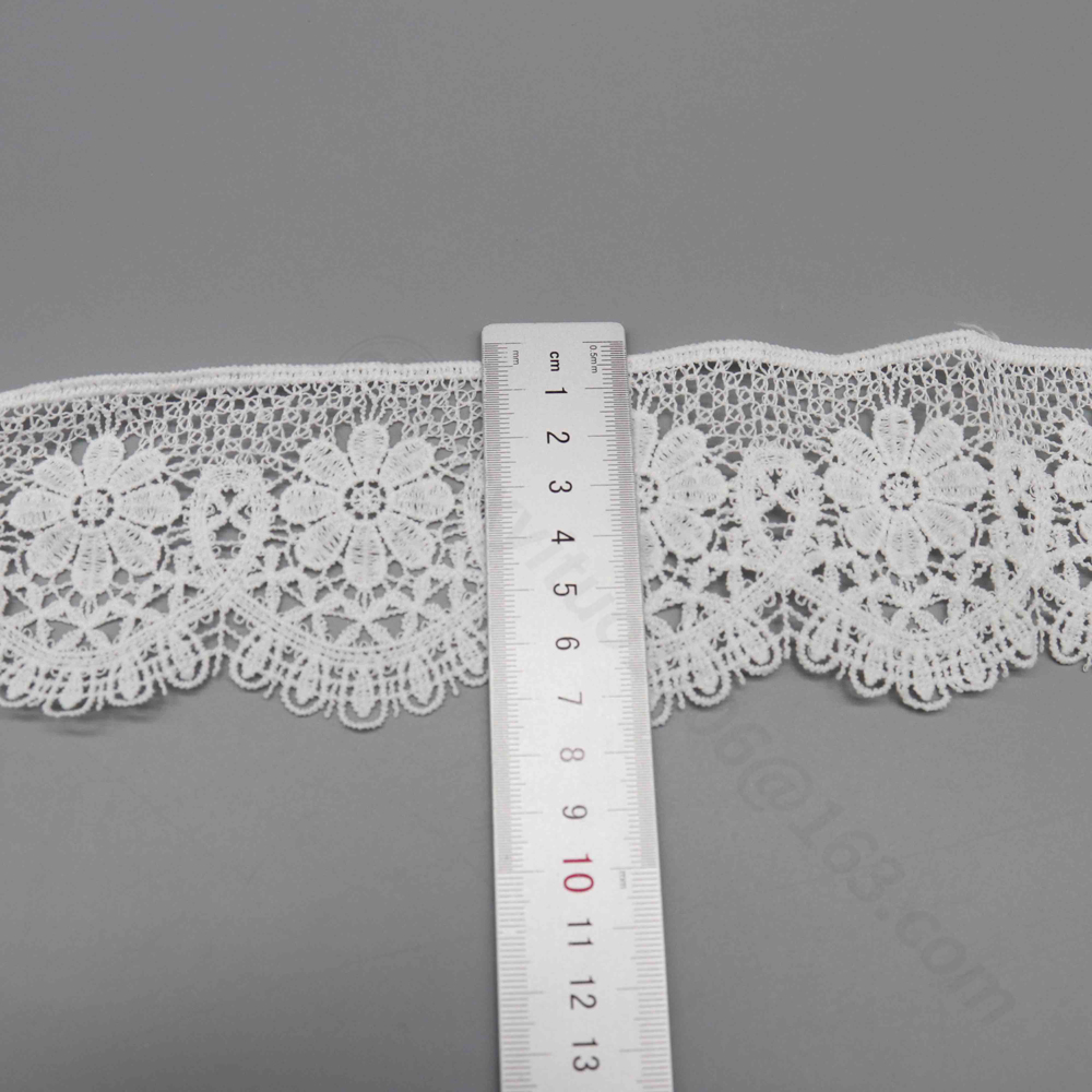 Artistic close-up of snow white water-soluble milk silk polyester lace trim