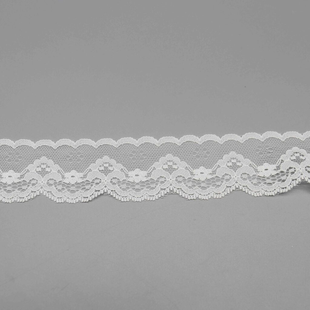 Vibrant image of delicate pure white scalloped floral lace ribbon