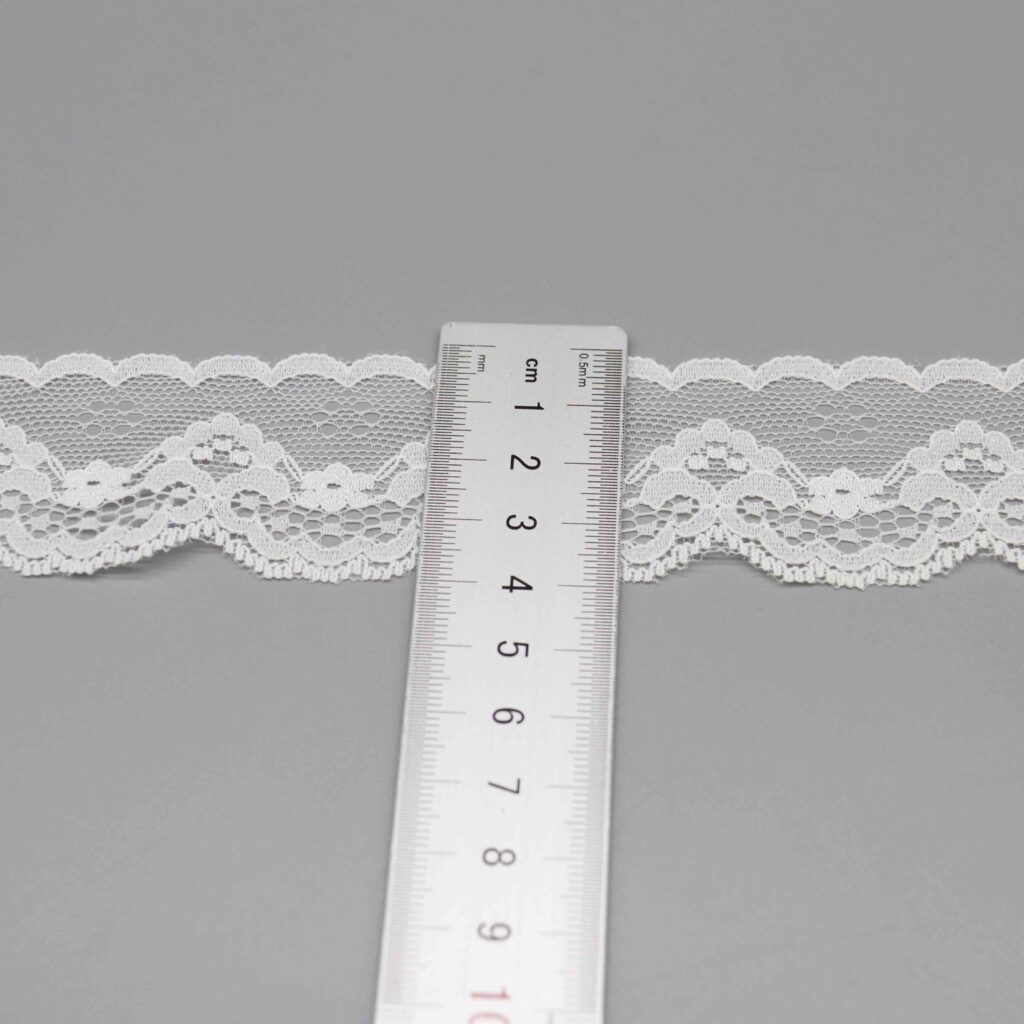 Artistic close-up of soft pure white lace trim ribbon
