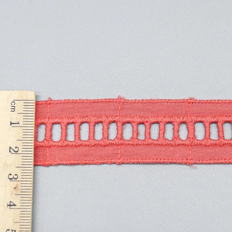 Ruler laid vertically across the lace trim showing the exact 2.7cm width measurement