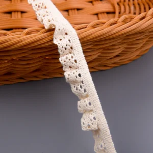 Macro shot of gathered ruffle crochet details and openwork eyelets on natural cotton spandex stretch lace trim.
