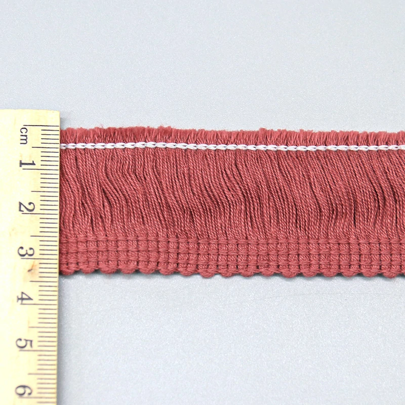 Three cotton fringe trims in dusty rose, sage green, and forest green displayed together