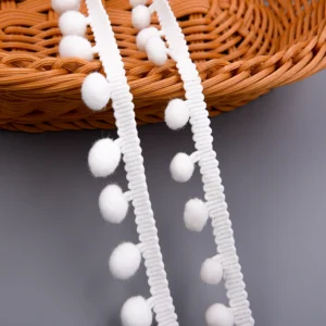 Top-down view of pompom trim showing uniform ball spacing and crochet pattern