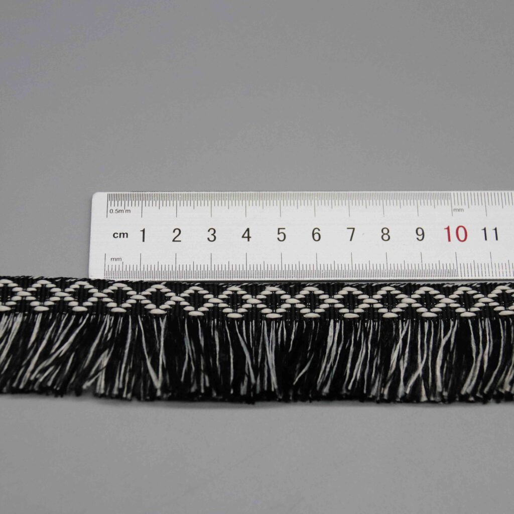 Ruler laid horizontally along the diamond pattern repeat showing scale and geometric spacing.