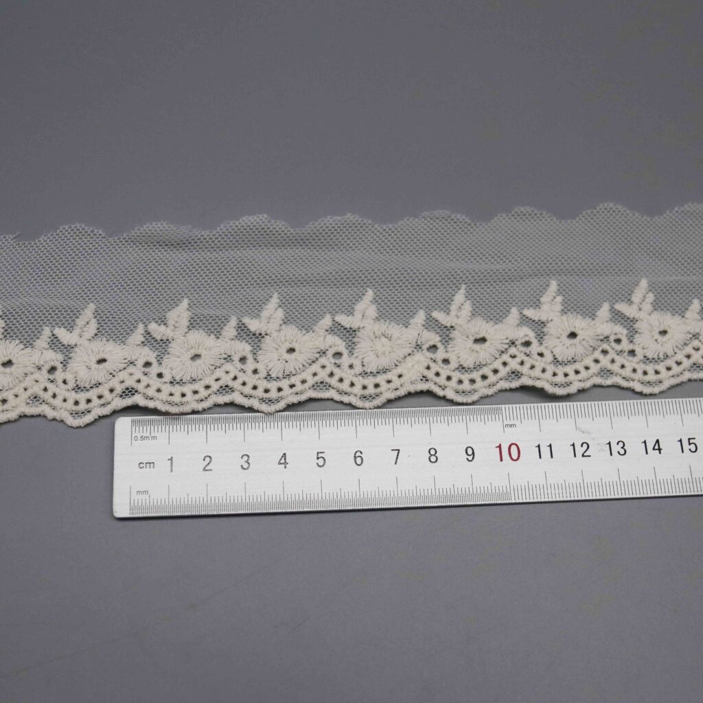 Ruler laid horizontally along the daisy pattern repeat showing floral motif spacing