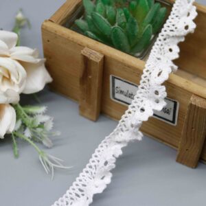 Front-facing shot showing the floral petal motifs and natural ruffle gathering clearly.