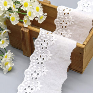 Front-facing shot of Broderie Anglaise Cotton Eyelet Embroidery Lace Trim, showing daisy cluster pattern and punched eyelets clearly.