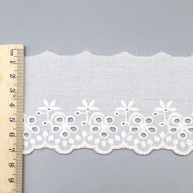 Ruler laid vertically across the lace trim showing the exact 6.8cm width measurement