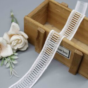 Front-facing shot showing the geometric ladder lace pattern and milk-silk polyester texture clearly.