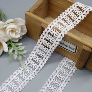 Front-facing shot showing the repeating daisy pattern and soft milk fiber texture clearly.