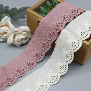 Front-facing shot showing scalloped broderie anglaise in dusty pink and off-white cotton embroidered lace.