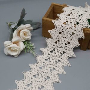 Front-facing shot showing geometric trellis pattern and natural matte cotton texture on cream embroidered lace.