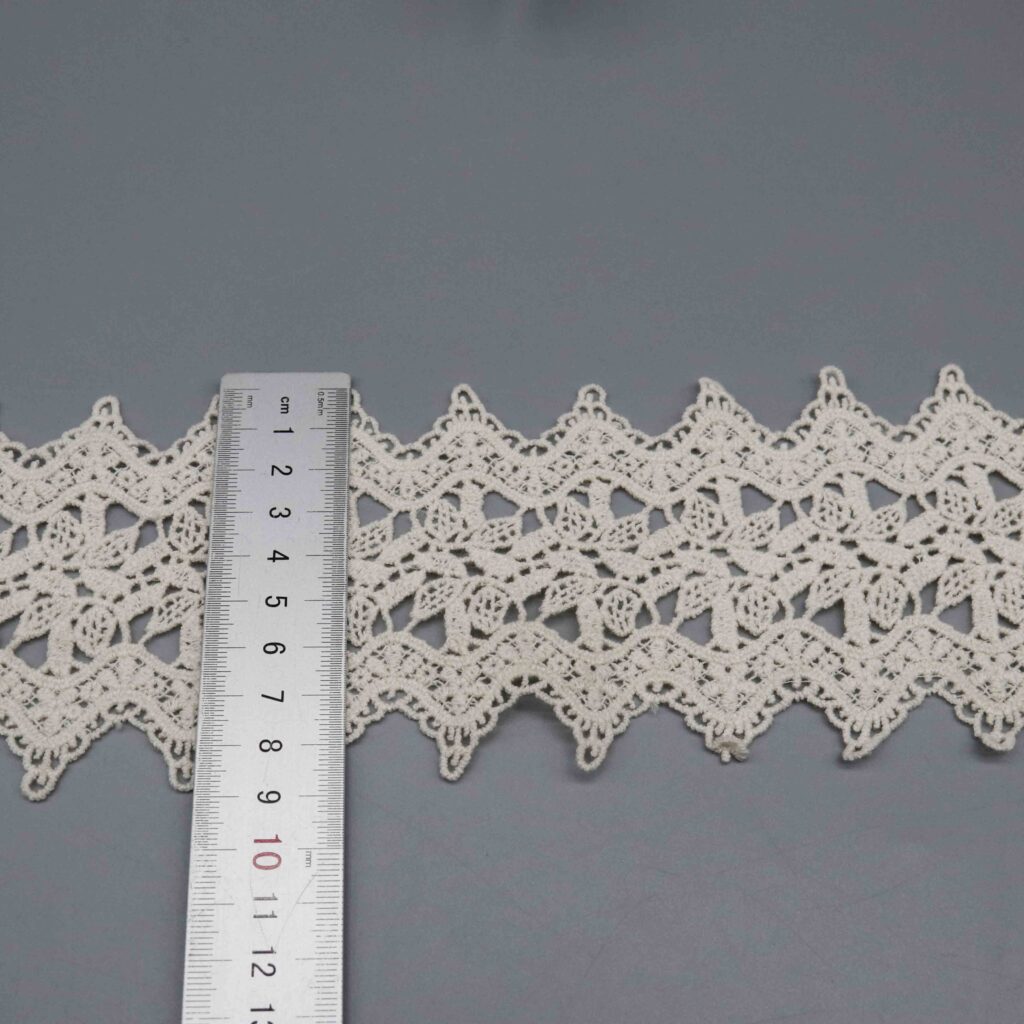 Vertical sizing gauge displaying exact 9cm dimension of wide decorative ribbon