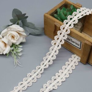 Front-facing shot showing symmetrical circular motifs and natural matte cotton texture on cream crochet lace.