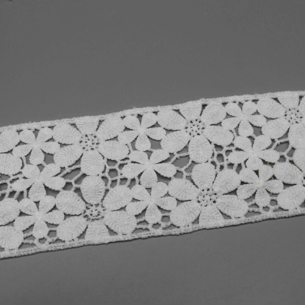 Angled view highlighting dimensional bullion leaf work and soft tactile sensation of premium polyester textile