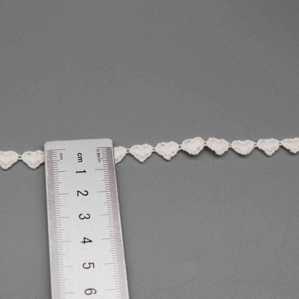 Vertical sizing gauge displaying exact 0.7cm dimension of narrow decorative ribbon
