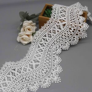 Front-facing shot showing elaborate multi-layered geometric patterns and lustrous milk fiber texture on white water-soluble lace.