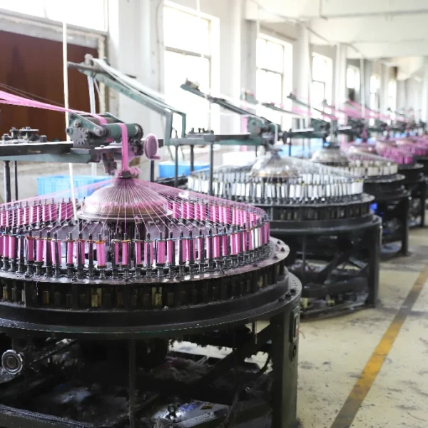 Technician performing quality checks on lace during factory production.