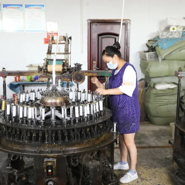 Automated machinery in use for lace and trim production in a factory.