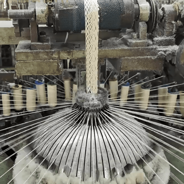 Interior view of a state-of-the-art cotton thread lace factory using automated embroidery systems for precise lace production.