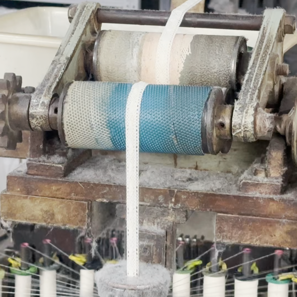 Interior of a cotton thread lace factory featuring automated embroidery machines producing high-quality lace trims efficiently.