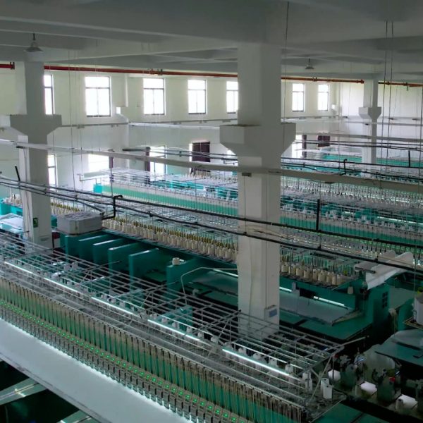 Modern lace production factory showcasing skilled technicians operating advanced embroidery machinery to manufacture premium quality lace.